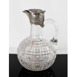 A 19th century silver and glass claret jug, with star hobnail panels, silver collar and cover