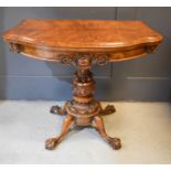 A fine VIctorian rosewood card table with carved decoration to the frieze, raised on a central colum