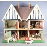 A vintage handmade dolls house complete with electric lighting and a large quantity of accessories