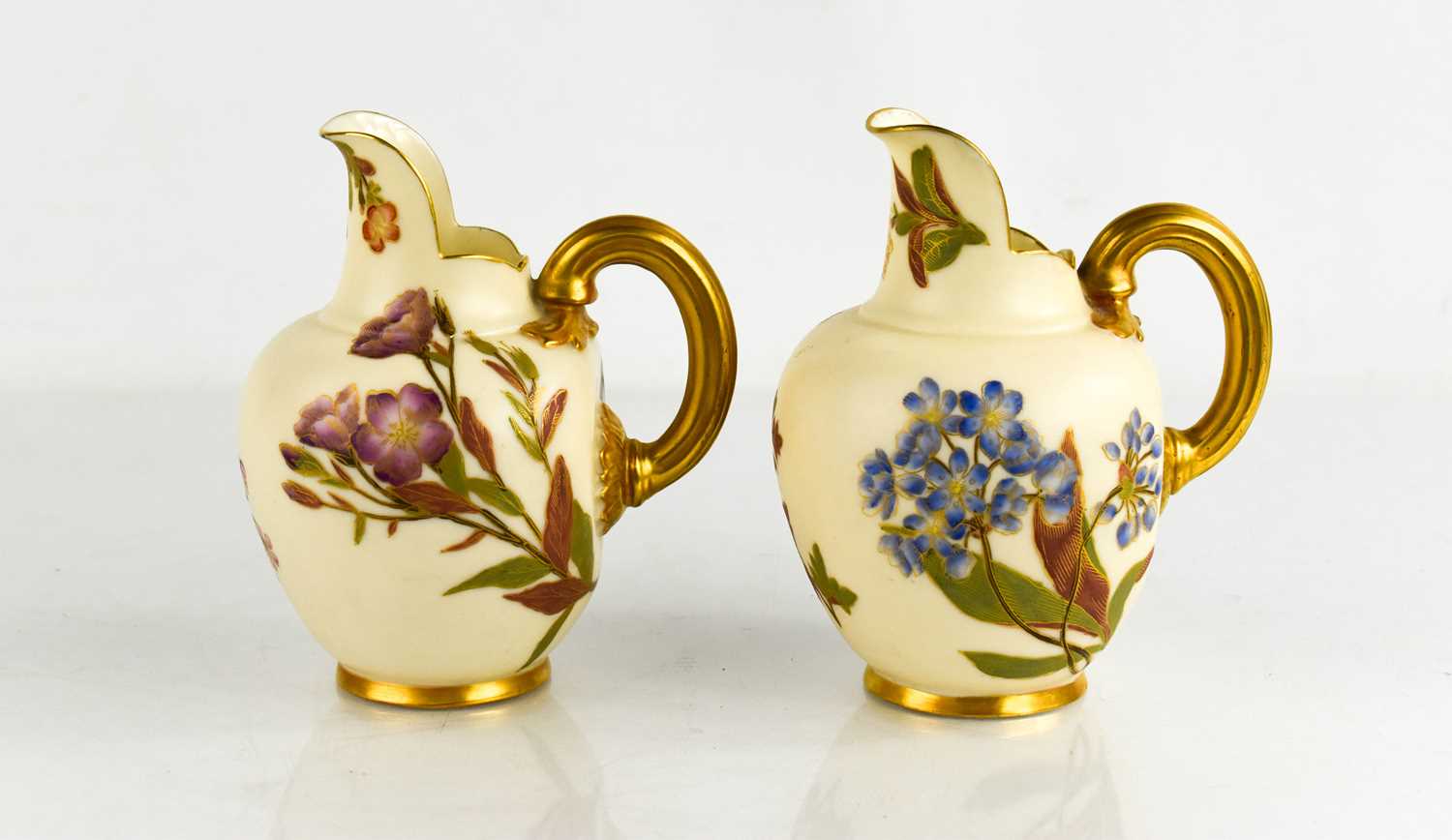 Two Royal Worcester flat back jugs, blush ground, painted with flowers, date code for 1888, 1890,