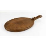 Robert Thompson 'Mouseman' oak oval cheese board, with carved mouse signature to the handle.