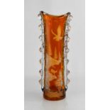 A tall amber and transluscent cut glass vase, the encased amber glass cut with an eagle aloft