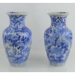 A pair of Chinese blue and white vases with floral decoration and decorative borders to base31cm