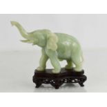 A Chinese jade carving of an elephant raised on a stand, 14cm high.