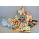 A group of vintage toys and books to include Dinky, Beatrix Potter stick puppet, dolls etc