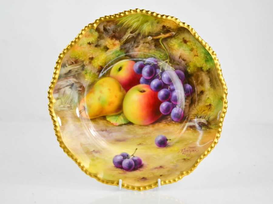 A Royal Worcester plate painted with fruit on a mossy ground, by Lockyer, circa 1930, signed, 26cm