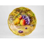 A Royal Worcester plate painted with fruit on a mossy ground, by Lockyer, circa 1930, signed, 26cm