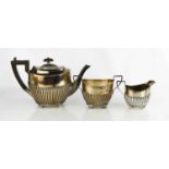 A silver tea set comprising tea pot, sugar bowl and milk jug, 19toz