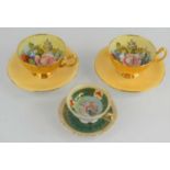 A pair of Aynsley handpainted cups and saucers signed by J.A Bailey, decorated with floral sprays