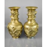A pair of 19th century Chinese brass vases, modelled with dragons, script to the base, 42cm high.