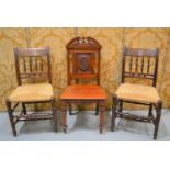 A Victorian hall chair, the back carved with a six petalled flower in the aesthetic manner,
