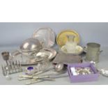 A quantity of pewter and silver plated items to include a claret jug, twin handled tankard, toast