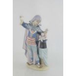 A Lladro clown, standing beside a magic hat with kittens, 5892, 28cm high