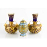 A pair of Royal Crown Derby vases, decorated with animals in giltwork on cobalt blue ground,