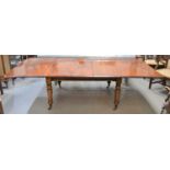 A Victorian mahogany dining table on turned legs, with brass castors, with extra leaves, 210 cm