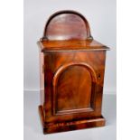 A Victorian walnut collectors cabinet, with an arched back above a door enclosing two short and
