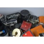 A group of vintage cameras and accessories to include Olympus Om20 35mm camera with Hoya 70-150