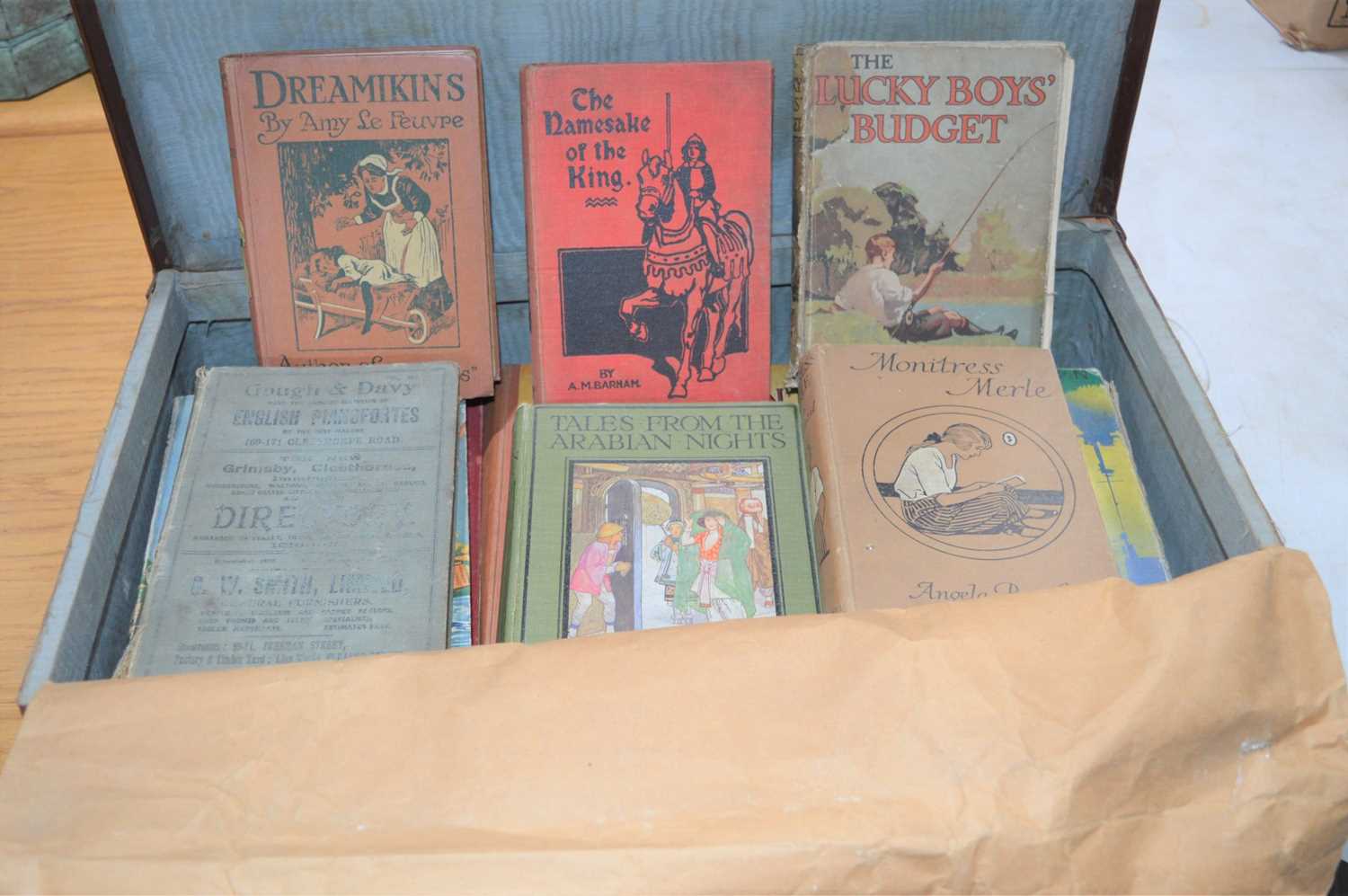 A vintage suitcase together with a quantity of antique childrens books