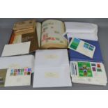 A quantity of first day covers together with a stamp album containing British and worldwide stamps