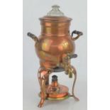 An early 20th century copper and brass coffee perculator with burner