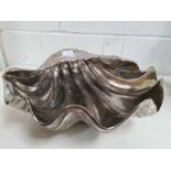 A large metal table ornament in the form of a giant clam shell - can be used as a 'wine cooler',