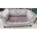 An Edwardian settee with drop down side.