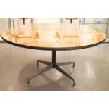 A Herman Miller action office circular top table with a brushed chrome base comprised of four