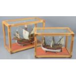 Two wooden model ships of the Nina and Pinta both in glass display cases.