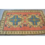 A Middle Eastern wool rug with peach ground and cream border with starburst motifs131cm by 209cm