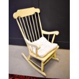 An antique pine painted kitchen rocking chair with cushion, 103cm.