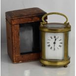 A 19th century French carriage clock, of oval form, with four glass panels, with the original