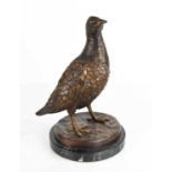 A 20th century bronze sculpture of a grouse, unsigned, raised on a marble base, 25cm high.