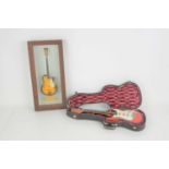 Two miniature collectible guitars, one in case the other framed