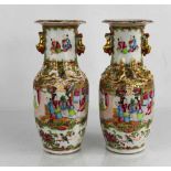 A pair of 19th century Chinese Canton famille rose vases, applied with dogs of fo to the necks, 25cm