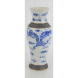 A 19th century Chinese stoneware blue and white vase depicting dragons, mark to base.25cm high