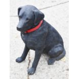 A resin garden statue of a black labrador, 67cm high.