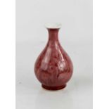 A small Chinese red mottled glazed baluster vase, with blue six character mark to the base, 12½cm