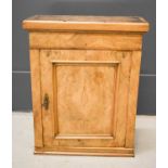 A walnut wall cabinet with single door and interior drawer converted to key safe with key