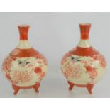 A pair of Japanese Kutani style vases raised on three feet depicting flowers and a bird.17.5cm high
