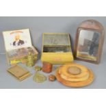 A group of collectable items to include halfpenny coins, horse brasses, leather framed mirror and