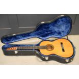 A Yamaha G-231 II classical guitar in a hard case.