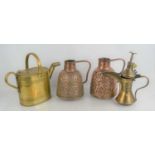 A Three Islamic brass and copper jugs together with a brass watering can.