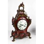 A French Louis XV red tortoiseshell mantle clock, the case mounted with gilt metal appliques, with