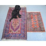 A Tekke type rug with red ground together with a Middle Eastern prayer mat with dark blue