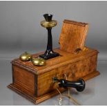 A part-Edwardian oak mounted brass and bakelite candlestick telephone, 51 by 22cm.