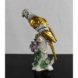 A 19th century Samson of Paris parrot perched on a tree stump, gold anchor mark to the base, 17cm