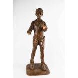 A treen carved German figure of a boy, painted brown, 60cm high.