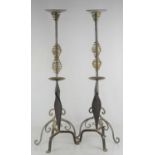 Two pairs of steel and wrought iron candle holders