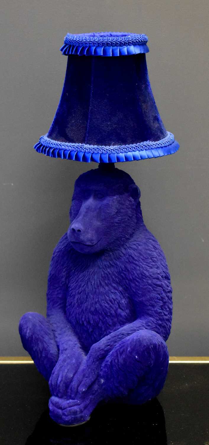 A modern table lamp in the form of a blue monkey