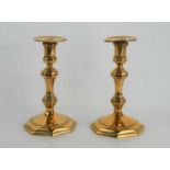 A pair of 19th century decorative brass candlesticks, with unusual faceted decoration, baluster